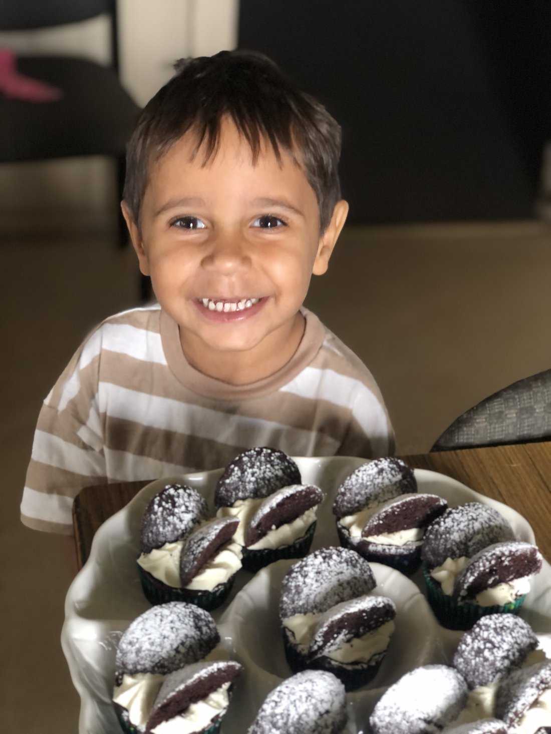 A young guest beaming over a plate of whoopie pies catered by Country Heart.