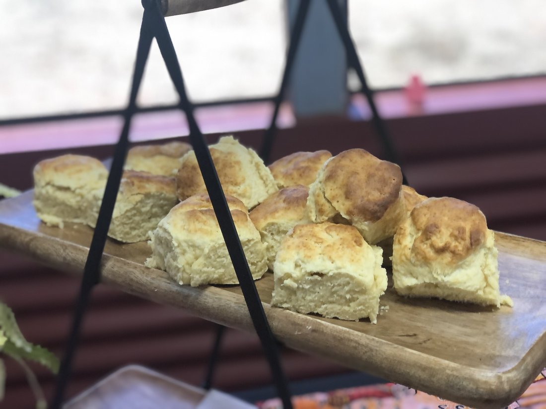 Fresh-baked scones served on a wooden board.