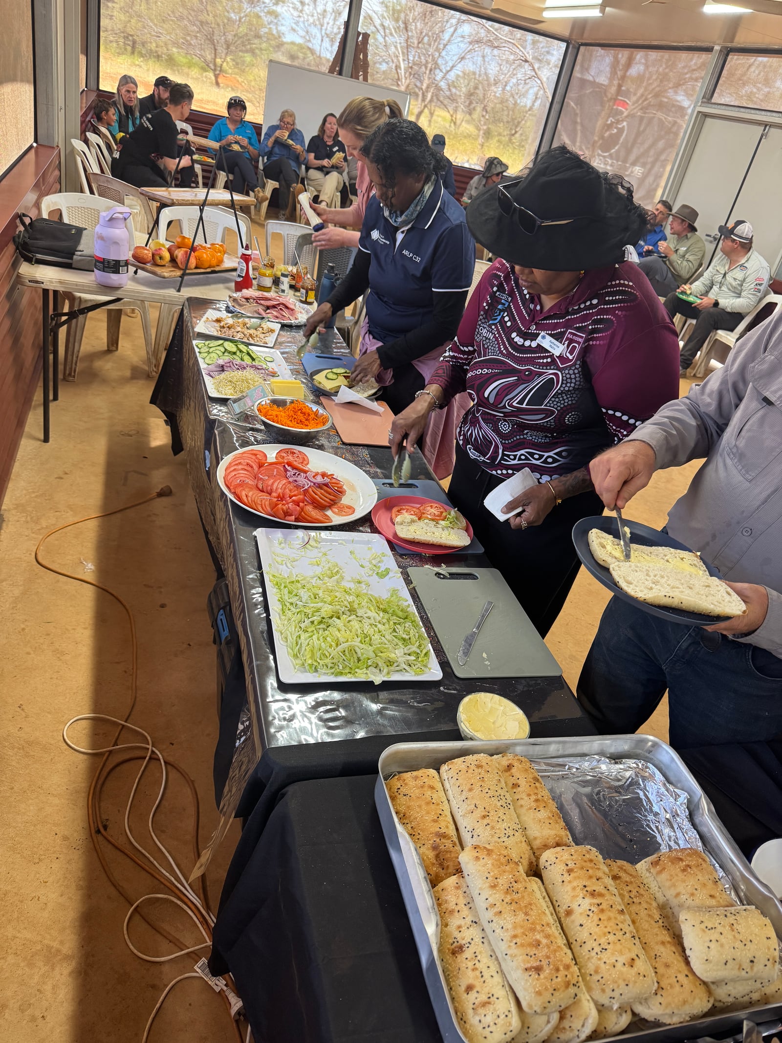 A community sandwich station with fresh rolls and salad fillings.