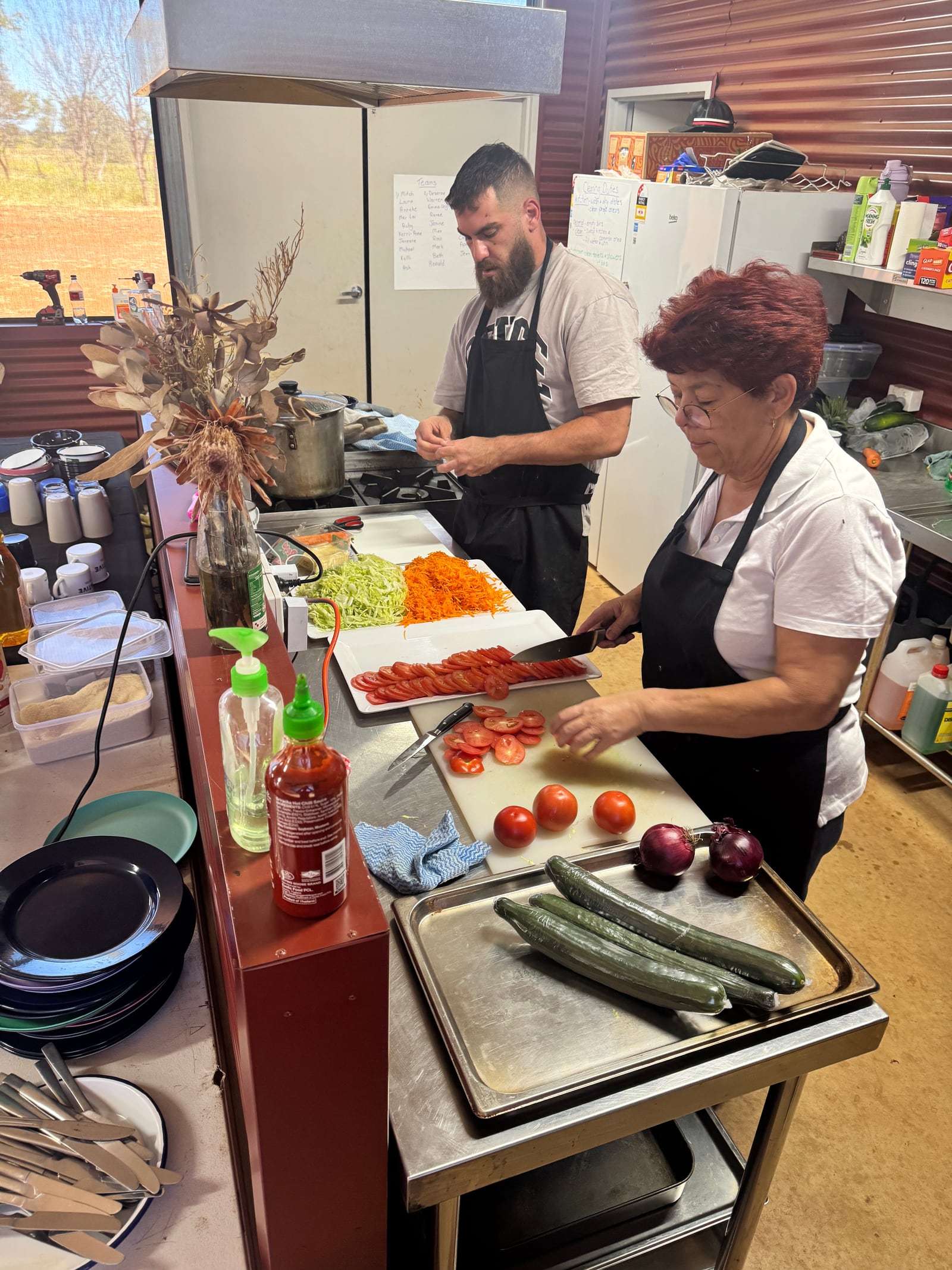 Aunty Donna and kitchen team preparing fresh vegetables and fillings.