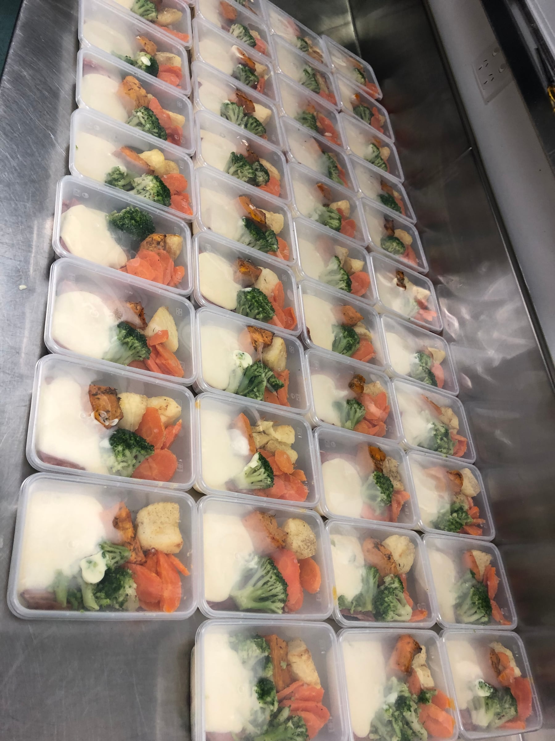 Rows of prepared roast meal containers ready for delivery.